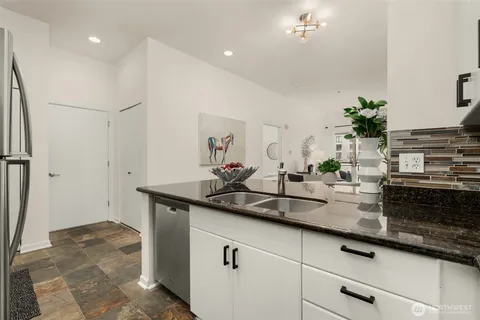 a kitchen with a sink and a refrigerator