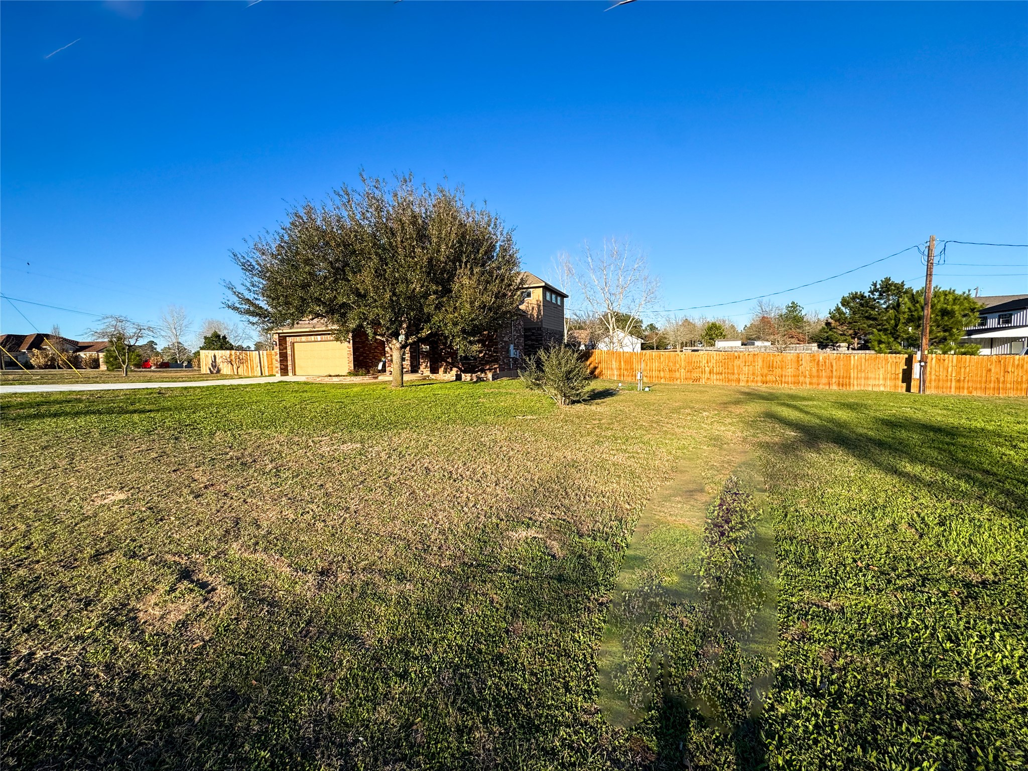 237 Cardinal Drive Paige, TX 78659 - Photo 3 of 37 View of yard featuring an attached garage