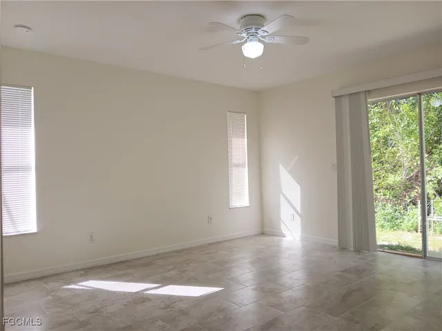 a view of room with window and ceiling fan