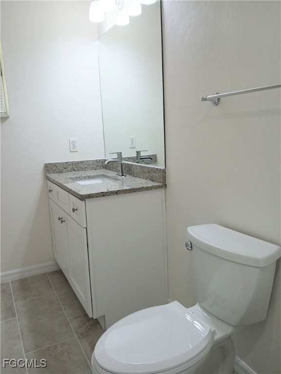 4613-4615 29th Street Southwest Lehigh Acres, FL 33973 - Photo 17 of 33 a bathroom with a granite countertop toilet and a sink