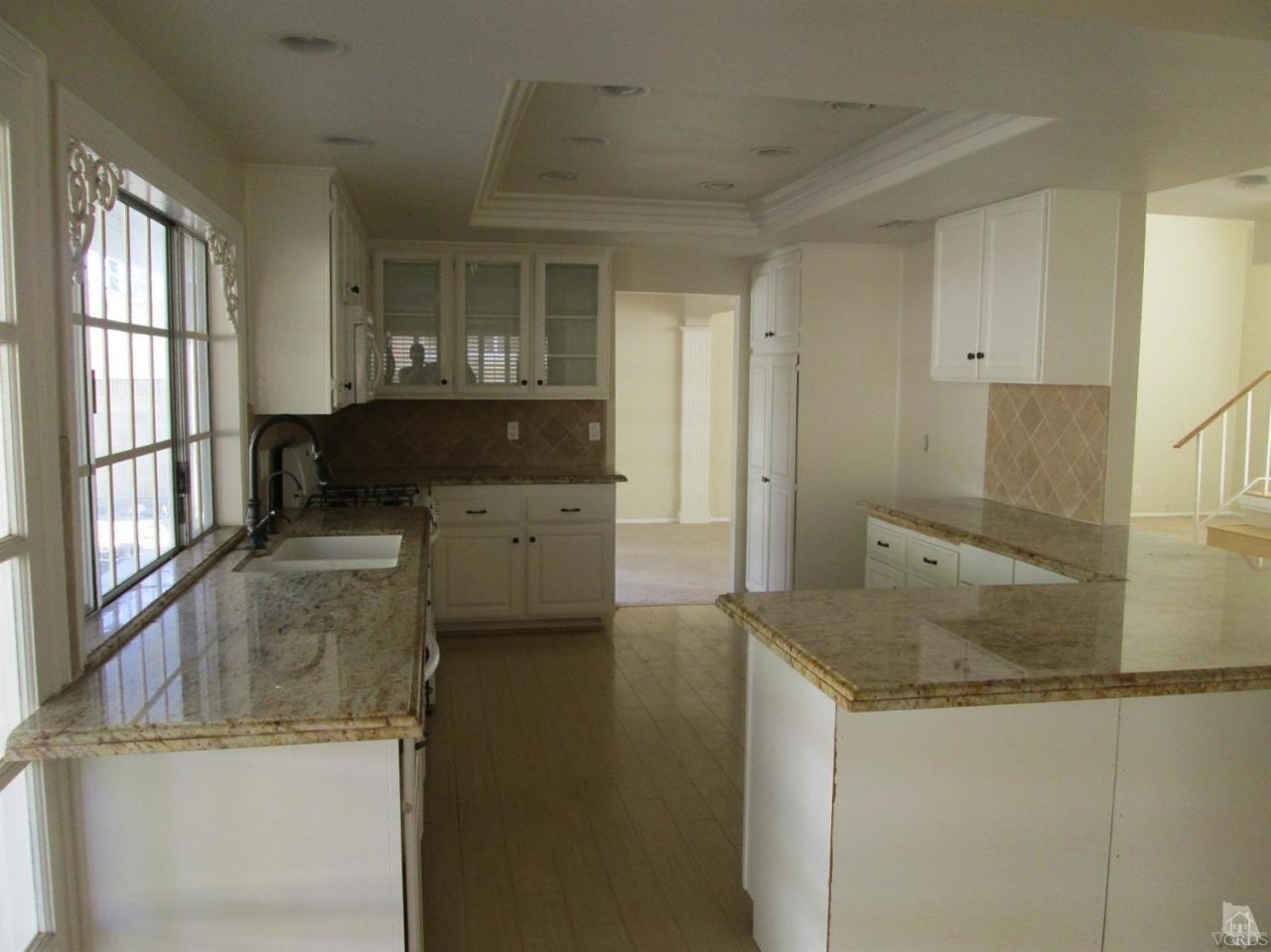 2287 Birchfield Street Simi Valley, CA 93065 - Photo 9 of 22 a kitchen with a sink stove and cabinets