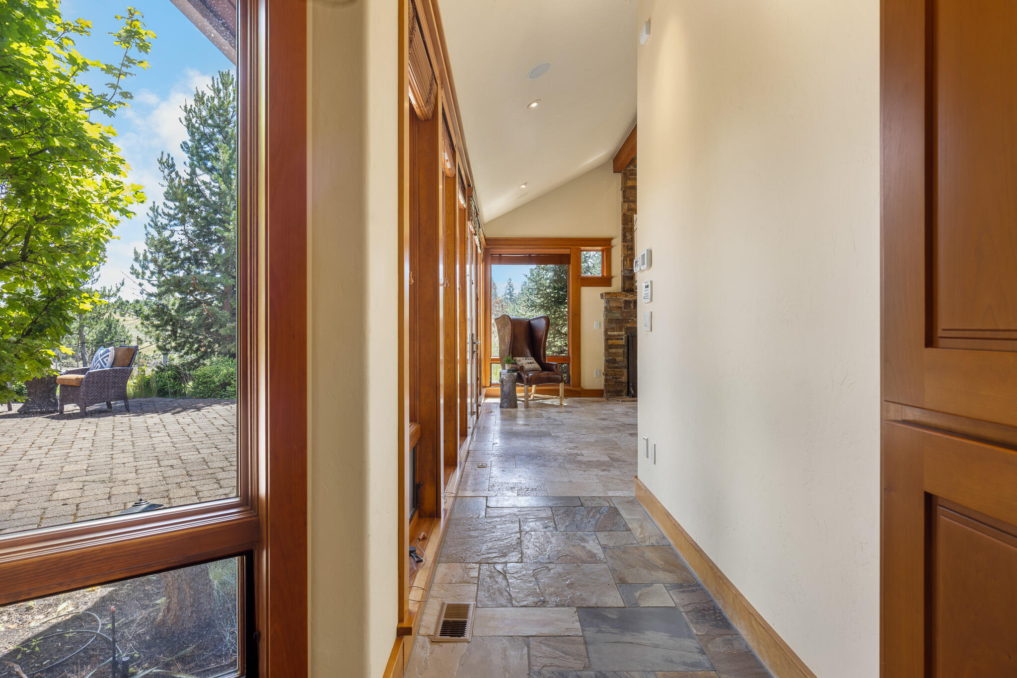 18883 Sutherland Court Bend, OR 97702 - Photo 22 of 70 Natural slate and stone guide the way through elegant hallways filled with texture and warmth.