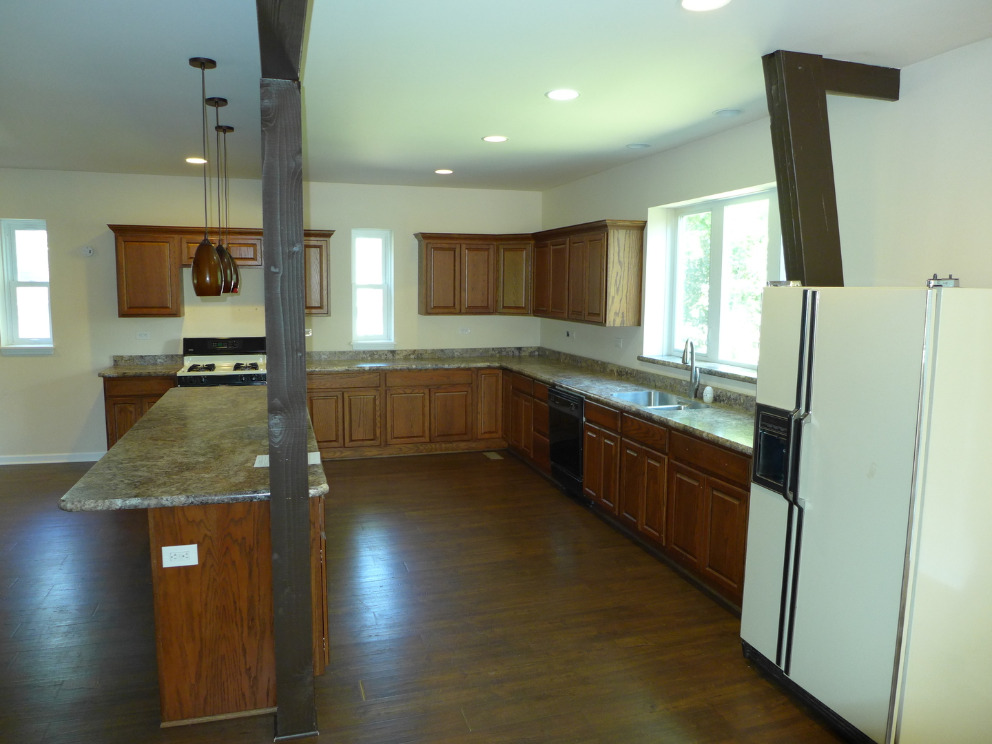 6316 Johnsburg Road Spring Grove, IL 60081 - Photo 14 of 29 a large kitchen with granite countertop a sink a counter top space and cabinets