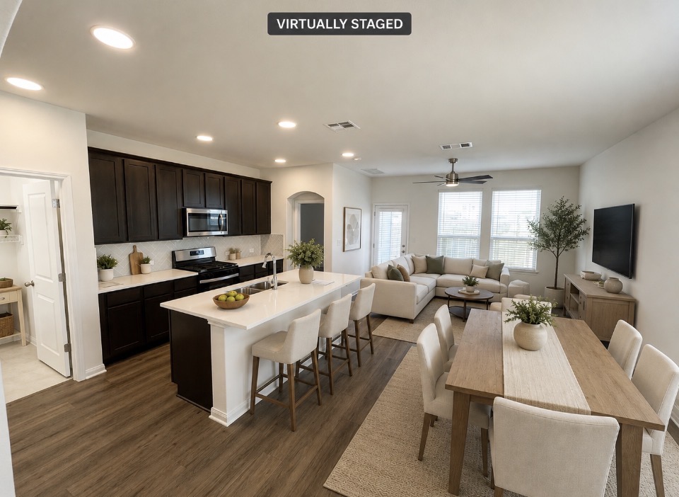8534 Wellspring Loop Round Rock, TX 78665 - Photo 5 of 32 An open-concept living space integrates a well-appointed kitchen, dining area, and comfortable lounge, perfect for entertaining.