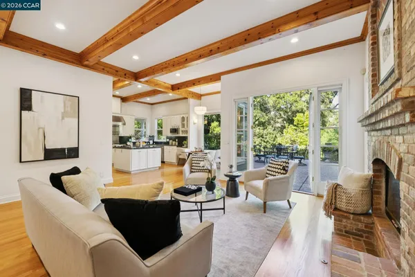 a living room with fireplace furniture and a large window