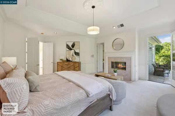 a spacious bedroom with a bed and a fireplace