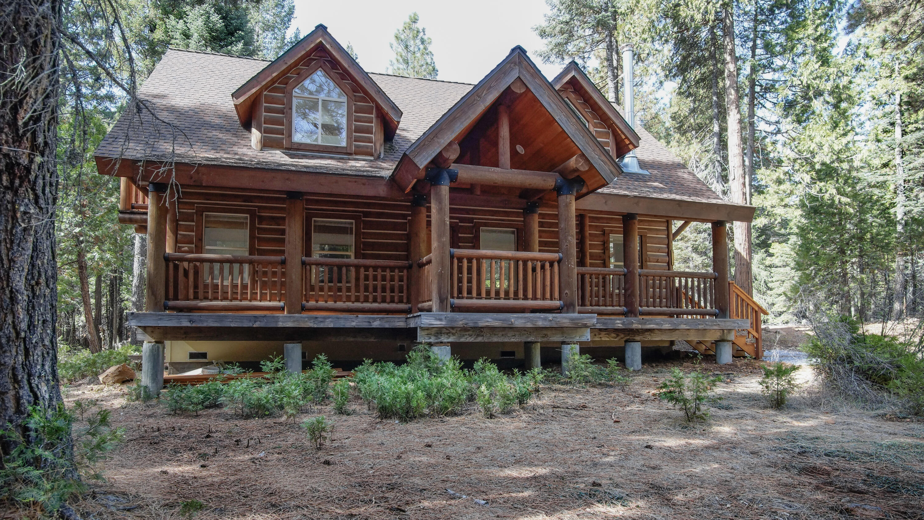 a front view of a house with a small deck and a yard
