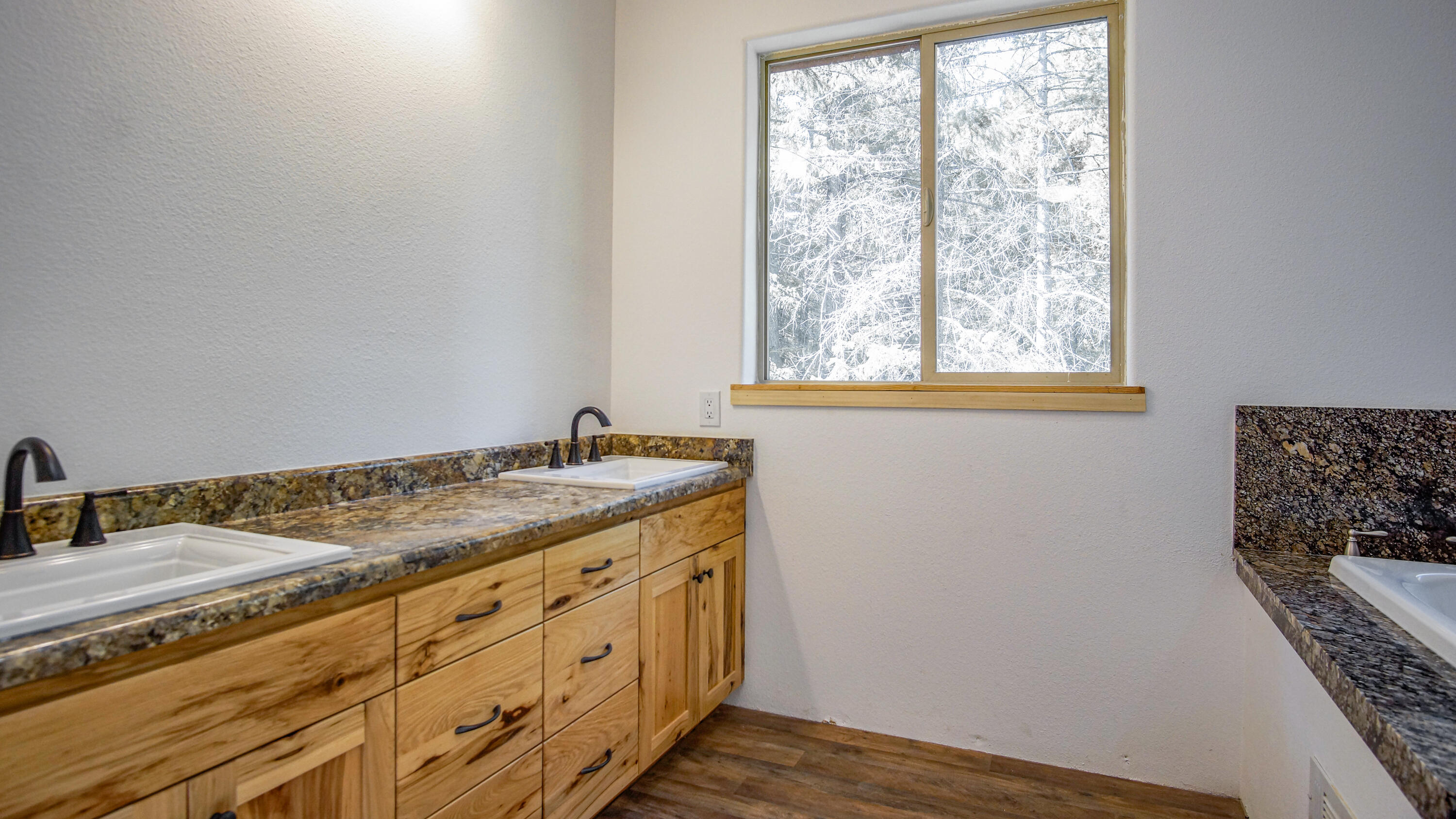 8118 Pine Forest Road Shingletown, CA 96088 - Photo 21 of 38 a bathroom with a granite countertop sink and a window