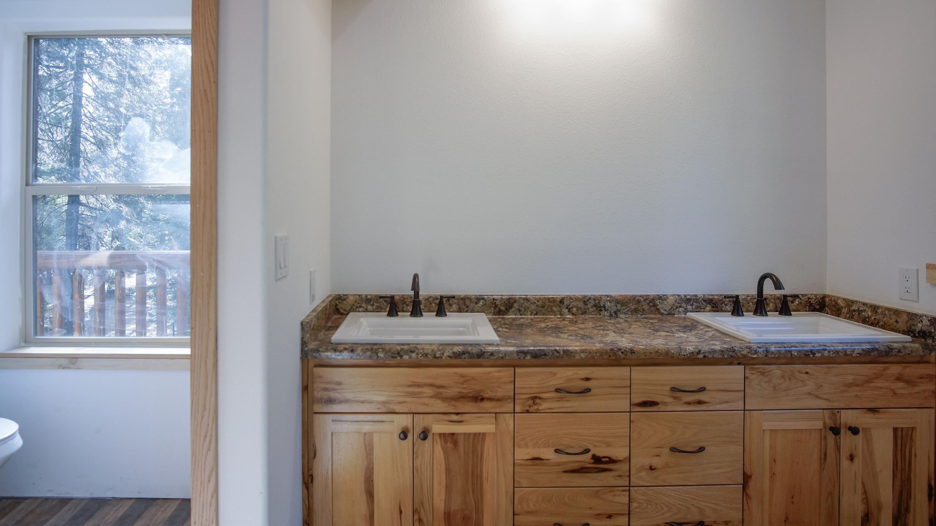 8118 Pine Forest Road Shingletown, CA 96088 - Photo 25 of 38 a bathroom with a granite countertop sink and a mirror