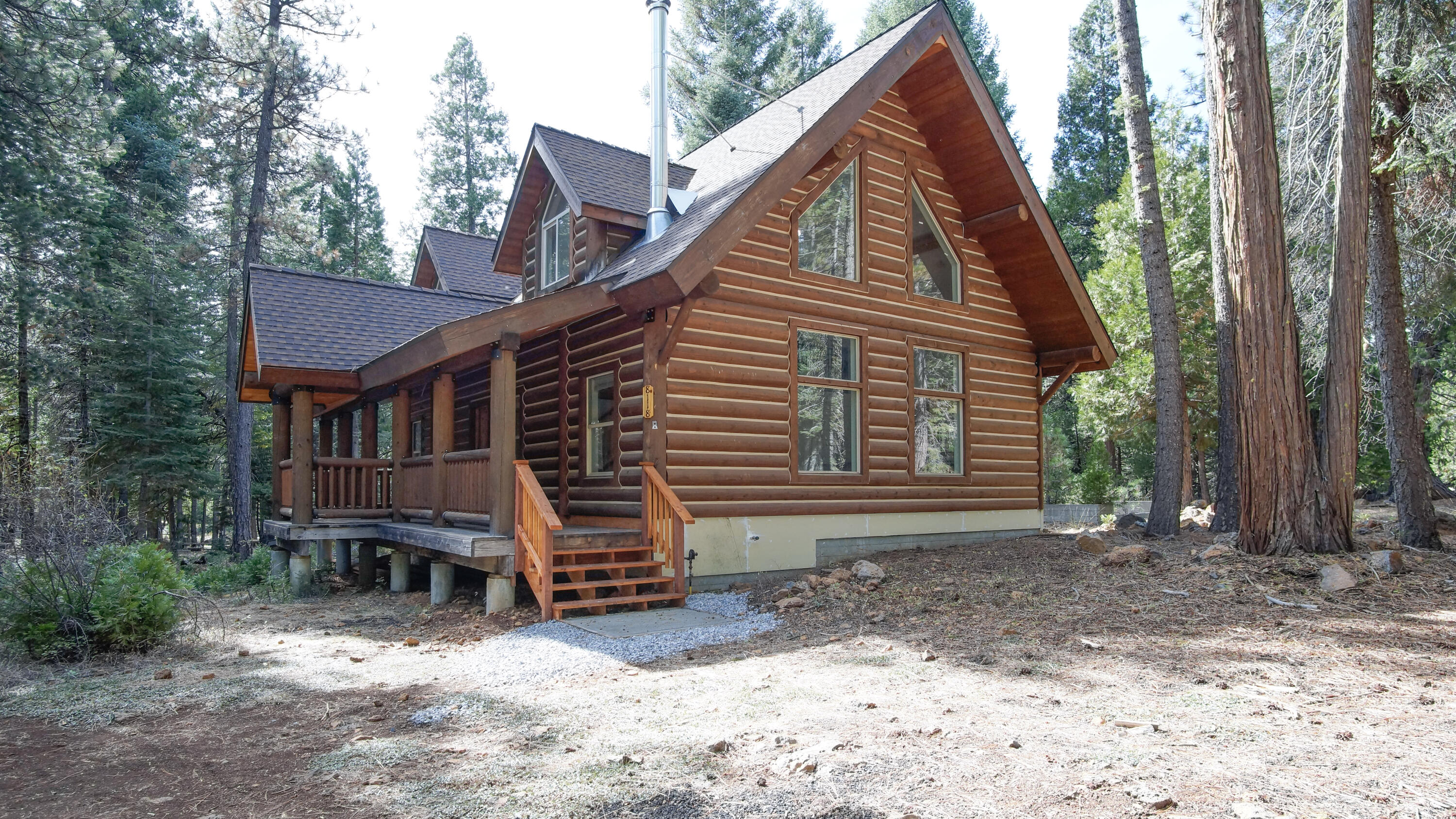 8118 Pine Forest Road Shingletown, CA 96088 - Photo 3 of 38 a view of a house with a yard and sitting area