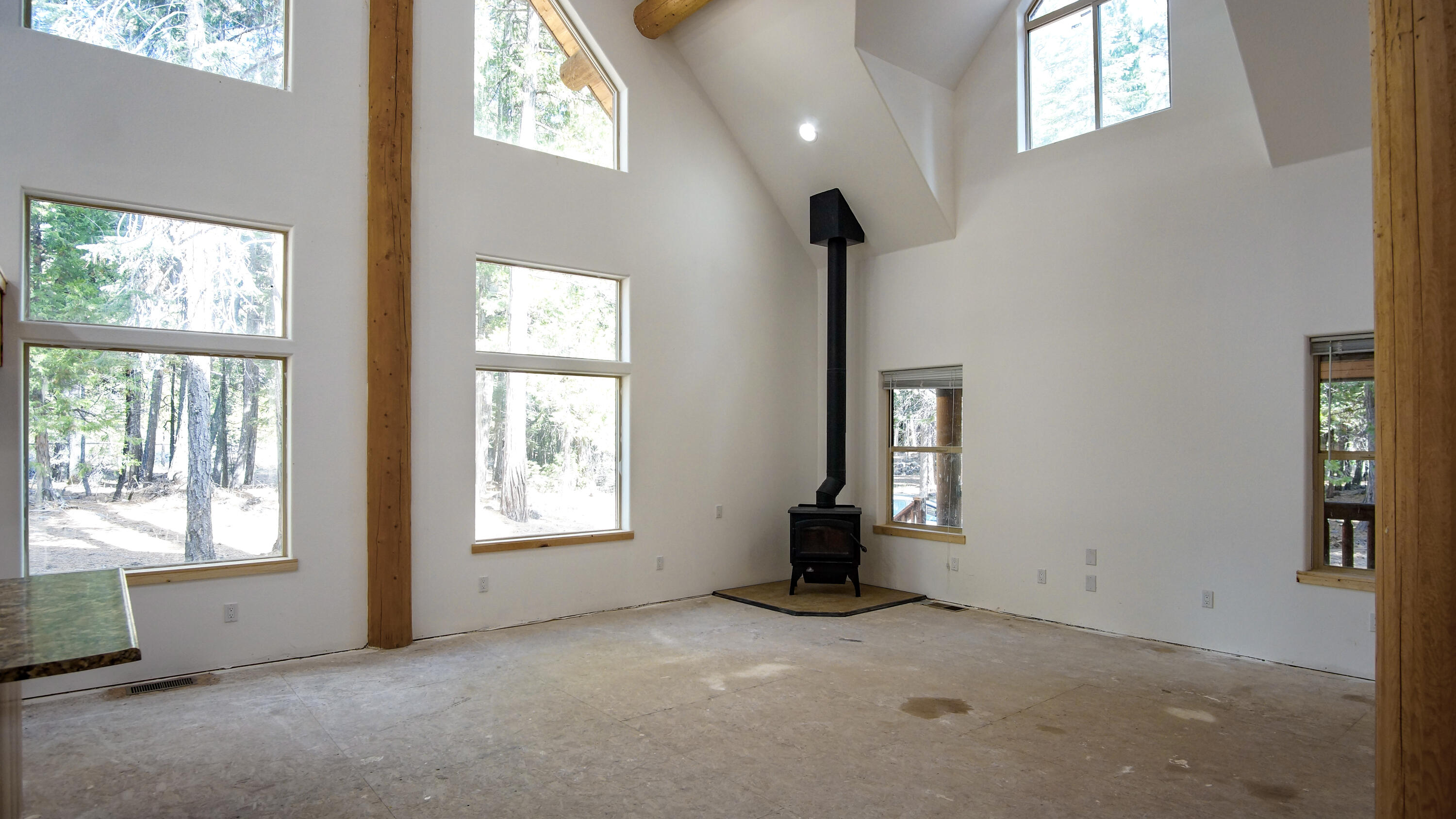 8118 Pine Forest Road Shingletown, CA 96088 - Photo 6 of 38 a view of an empty room with window and fireplace