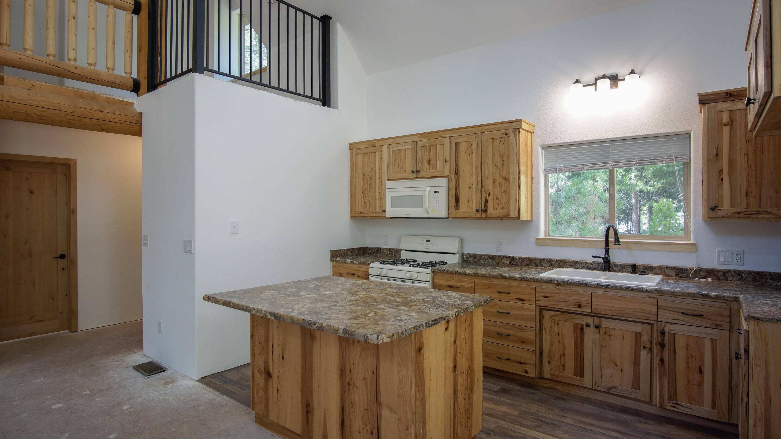 8118 Pine Forest Road Shingletown, CA 96088 - Photo 7 of 38 a kitchen with a sink stove and cabinets