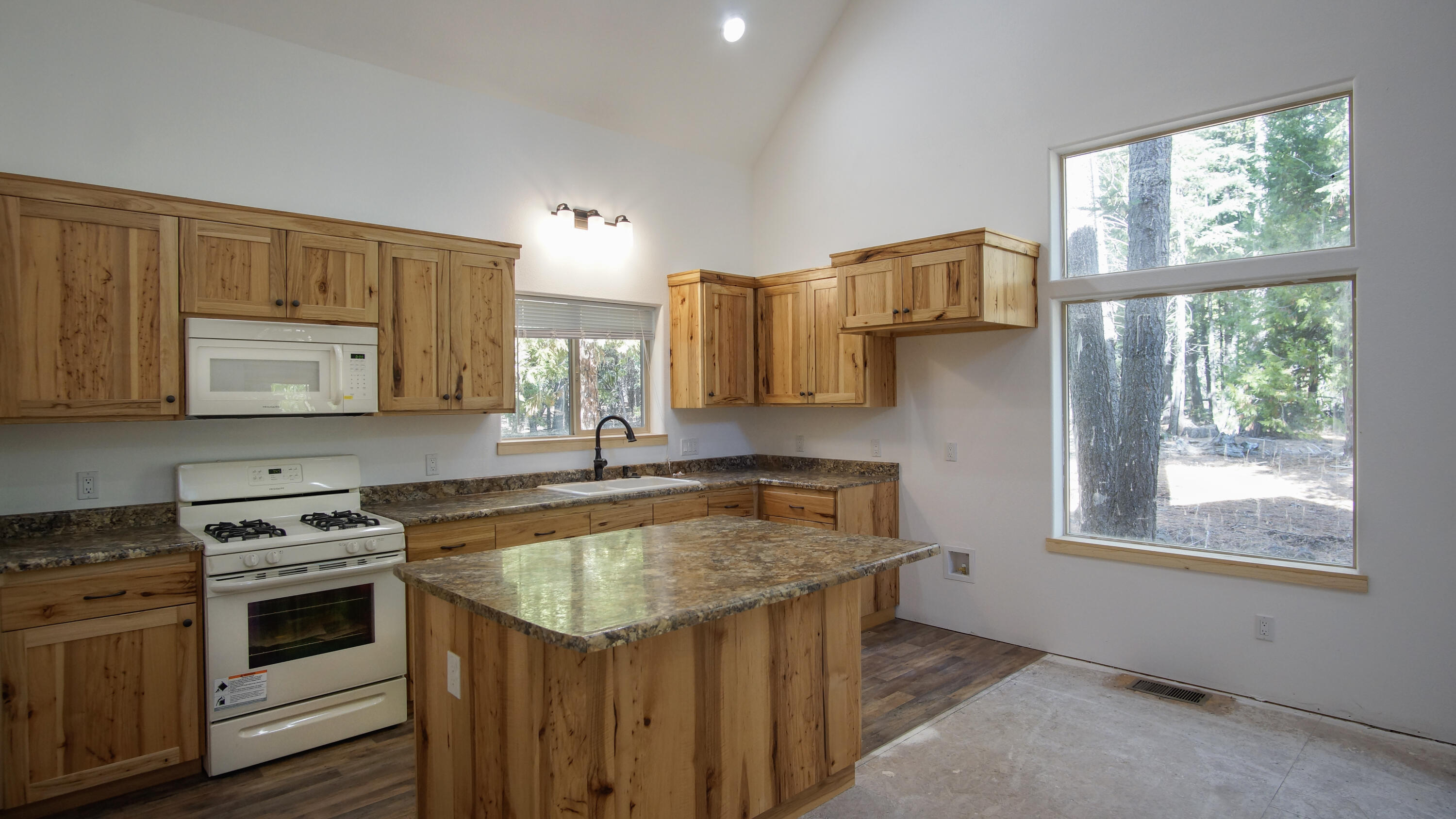 8118 Pine Forest Road Shingletown, CA 96088 - Photo 8 of 38 a kitchen with stainless steel appliances granite countertop a sink stove and microwave