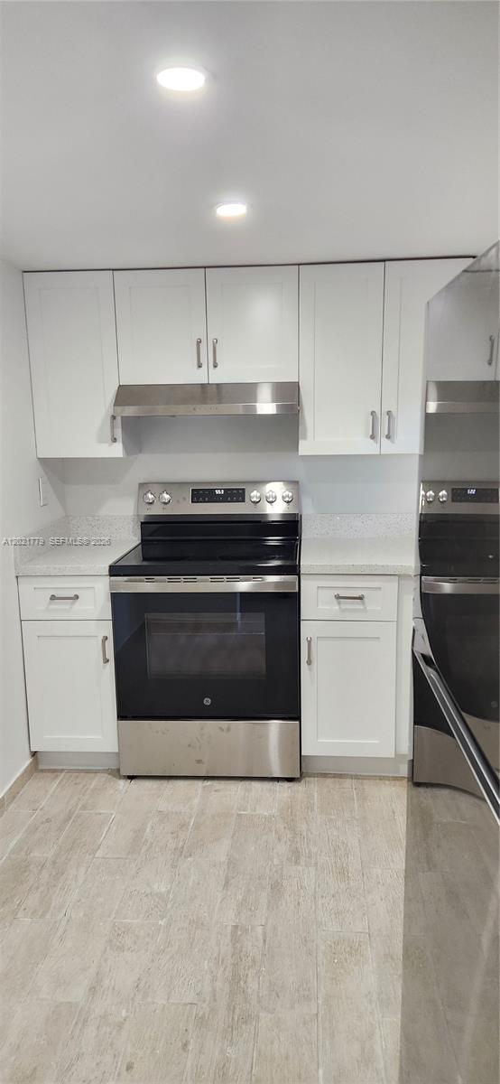 11800 Southwest 18th Street, Unit 4094 Miami, FL 33175 - Photo 3 of 14 a stove top oven sitting inside of a kitchen