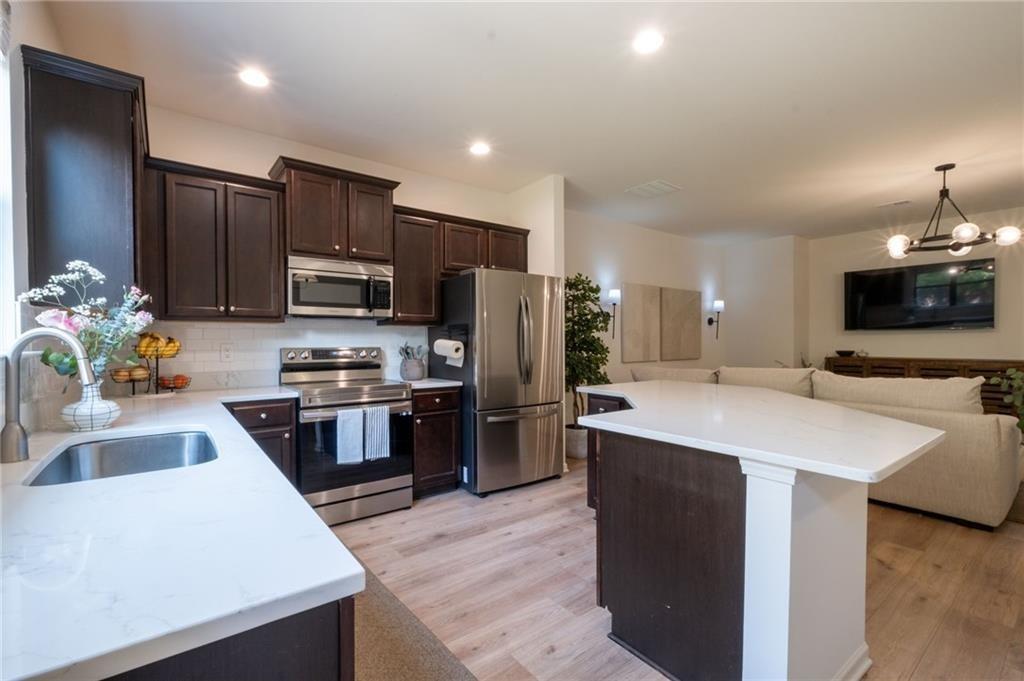 3950 Cyrus Crest Circle Northwest Kennesaw, GA 30152 - Photo 11 of 44 a kitchen with a sink stove and refrigerator
