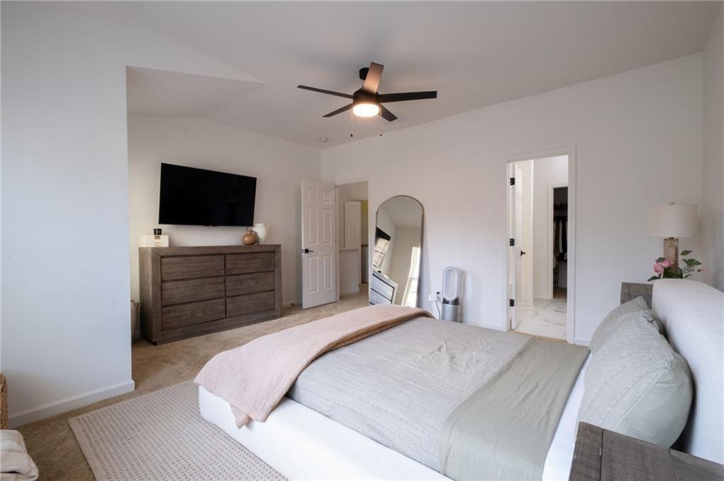 3950 Cyrus Crest Circle Northwest Kennesaw, GA 30152 - Photo 15 of 44 a bedroom with a bed and a flat screen tv