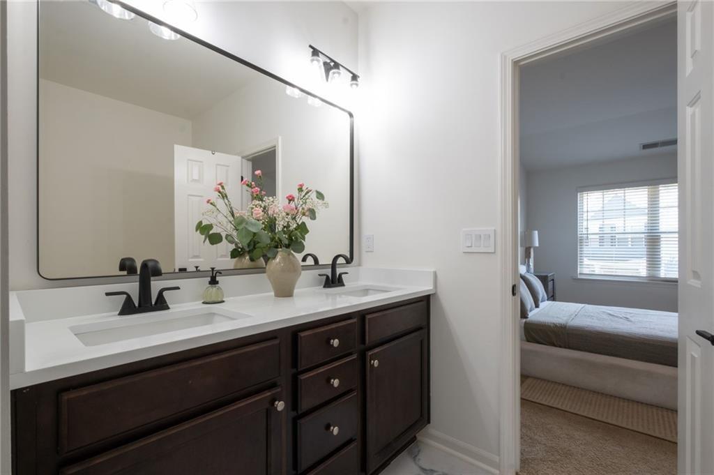 3950 Cyrus Crest Circle Northwest Kennesaw, GA 30152 - Photo 18 of 44 a bathroom with a sink double vanity granite and a mirror