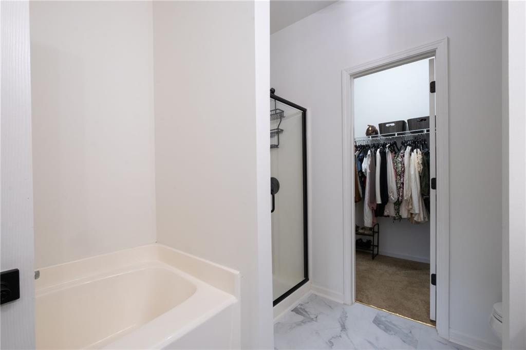 3950 Cyrus Crest Circle Northwest Kennesaw, GA 30152 - Photo 22 of 44 a bathroom with a bathtub and a shower