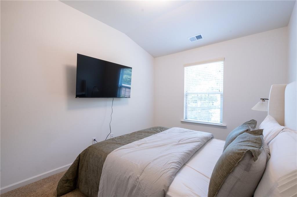 3950 Cyrus Crest Circle Northwest Kennesaw, GA 30152 - Photo 30 of 44 a bedroom with a bed and a flat screen tv