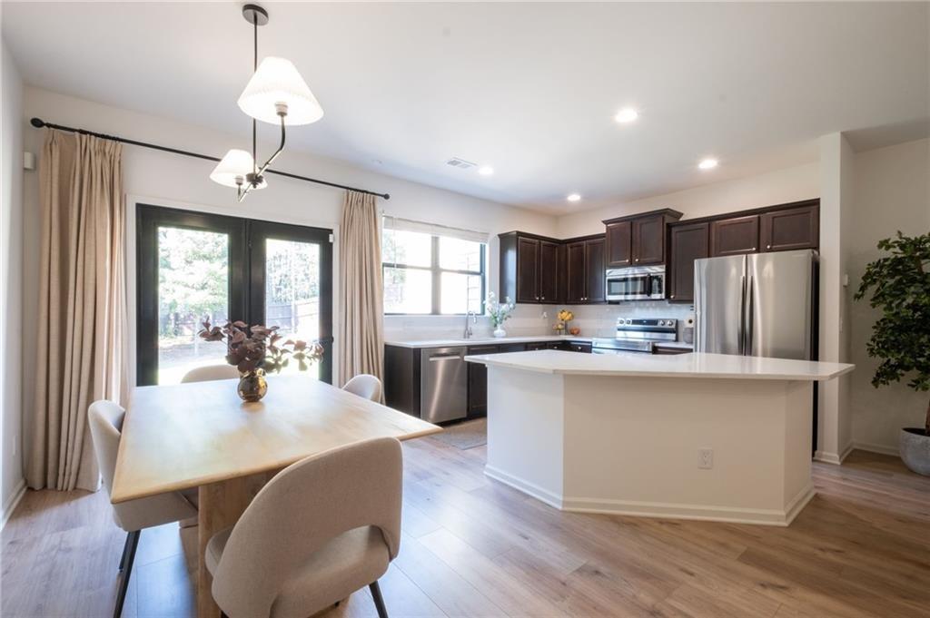 3950 Cyrus Crest Circle Northwest Kennesaw, GA 30152 - Photo 3 of 44 a kitchen with refrigerator a stove and center island