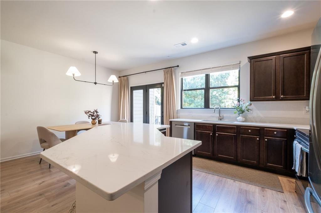 3950 Cyrus Crest Circle Northwest Kennesaw, GA 30152 - Photo 4 of 44 a large kitchen with sink a refrigerator and chairs