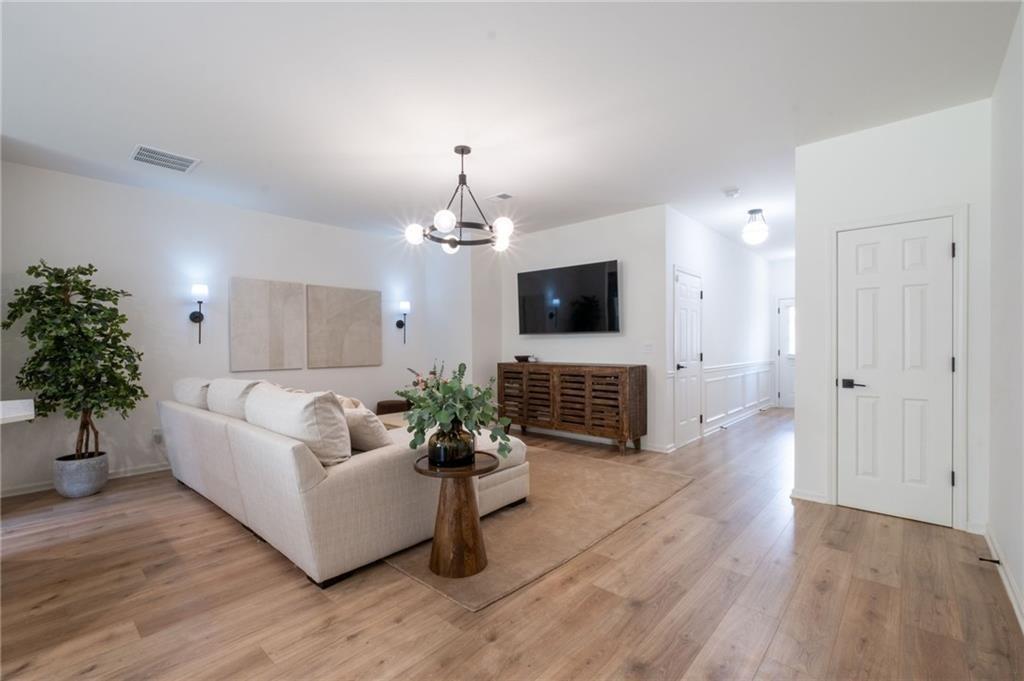 3950 Cyrus Crest Circle Northwest Kennesaw, GA 30152 - Photo 41 of 44 a living room with furniture potted plant and a flat screen tv