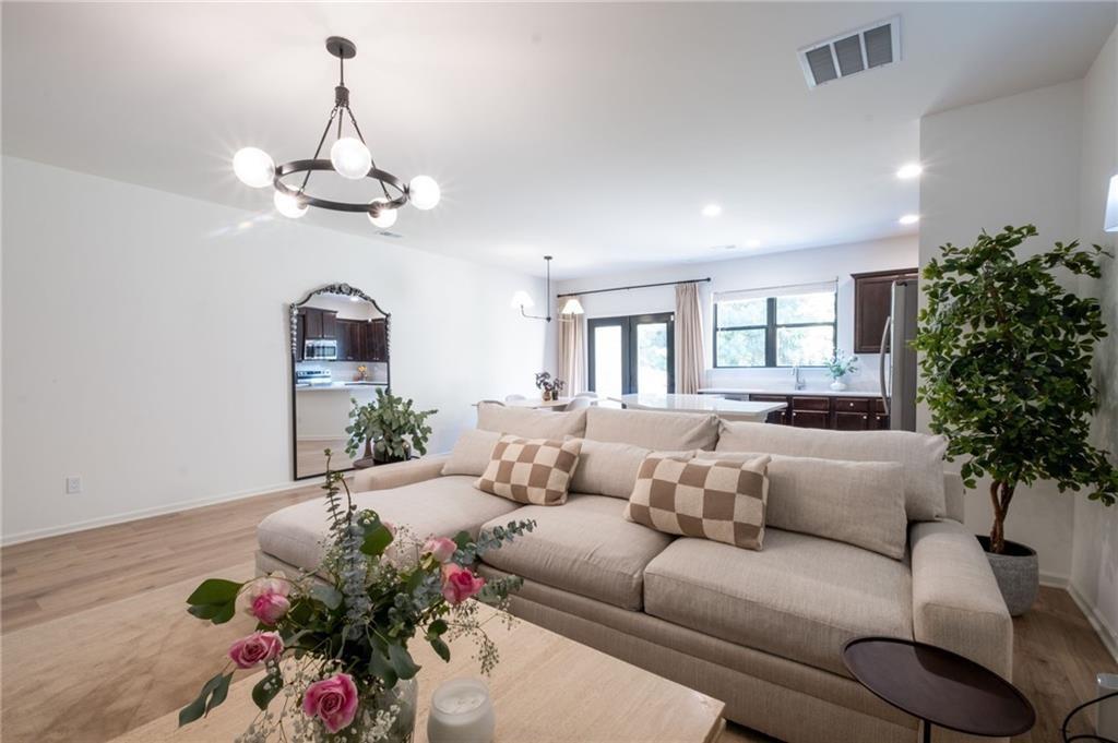 3950 Cyrus Crest Circle Northwest Kennesaw, GA 30152 - Photo 42 of 44 a living room with furniture and a chandelier