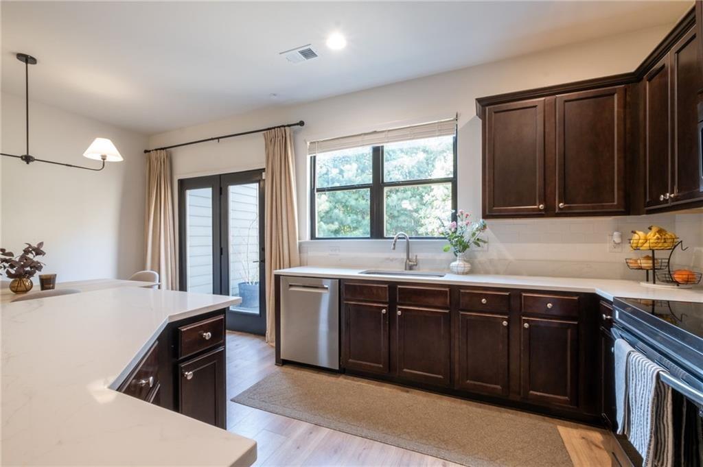 3950 Cyrus Crest Circle Northwest Kennesaw, GA 30152 - Photo 6 of 44 a kitchen with stainless steel appliances granite countertop a sink stove and refrigerator