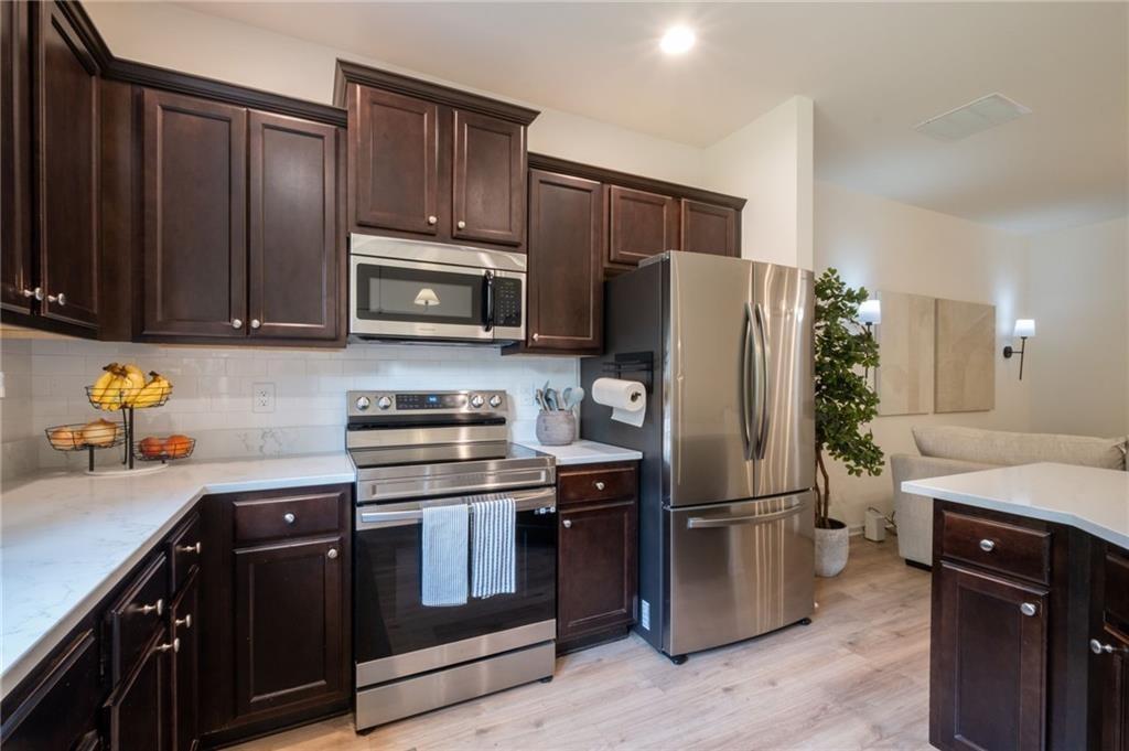 3950 Cyrus Crest Circle Northwest Kennesaw, GA 30152 - Photo 9 of 44 a kitchen with a refrigerator sink and microwave
