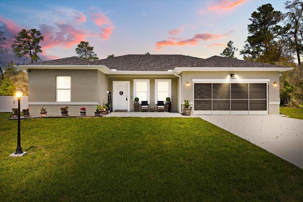 13657 Southwest 33rd Circle Ocala, FL 34473 - Photo 1 of 26 a view of a backyard with a garden and plants