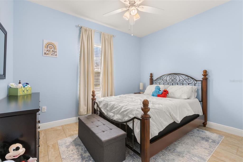 13657 Southwest 33rd Circle Ocala, FL 34473 - Photo 14 of 26 a bedroom with a bed and a window