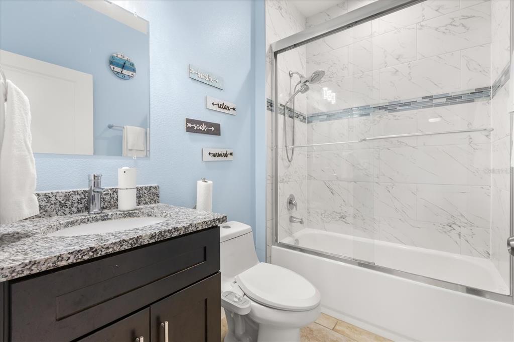 13657 Southwest 33rd Circle Ocala, FL 34473 - Photo 15 of 26 a bathroom with a granite countertop sink toilet and shower