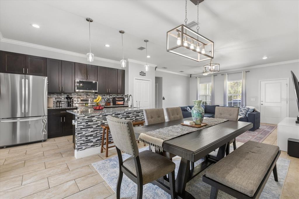 13657 Southwest 33rd Circle Ocala, FL 34473 - Photo 5 of 26 a view of a dining room and livingroom kitchen island