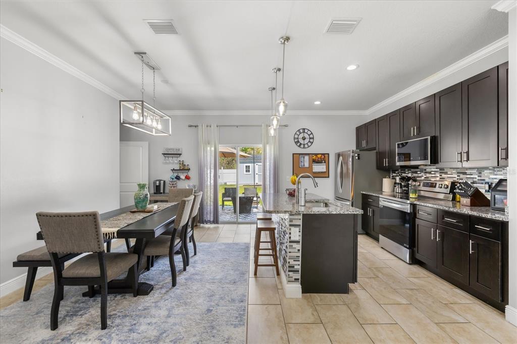 13657 Southwest 33rd Circle Ocala, FL 34473 - Photo 6 of 26 a large kitchen with cabinets table and chairs