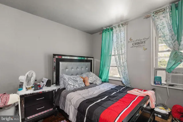 a bedroom with a bed and a window