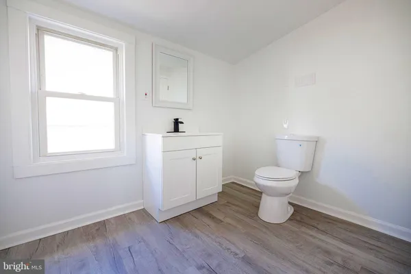 a white toilet sitting next to a bathroom sink