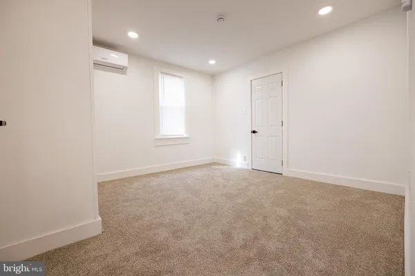 an empty room with windows and closet