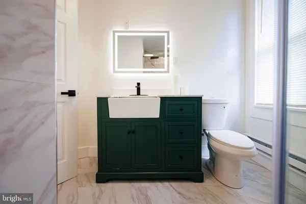 a bathroom with a toilet sink and mirror