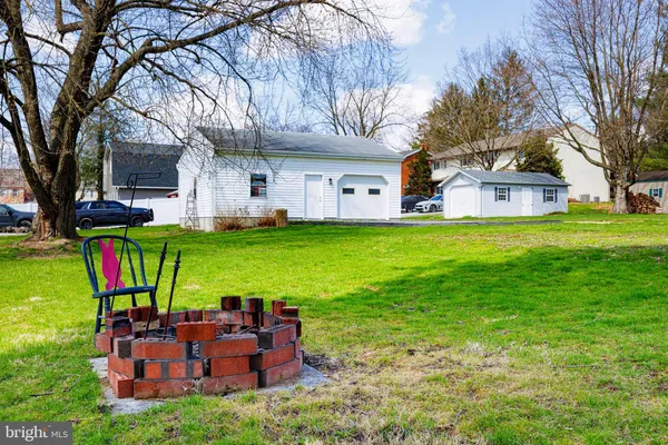 a view of a house with backyard and a patio