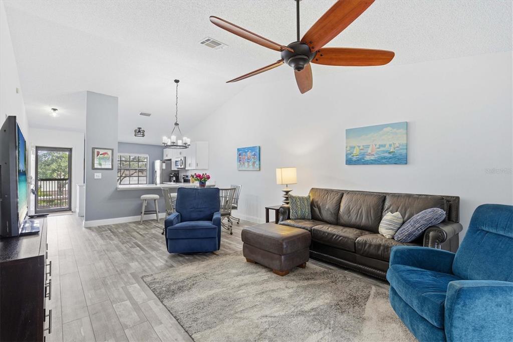 2178 Elm Street, Unit 1007 Dunedin, FL 34698 - Photo 14 of 28 a living room with furniture and a view of kitchen