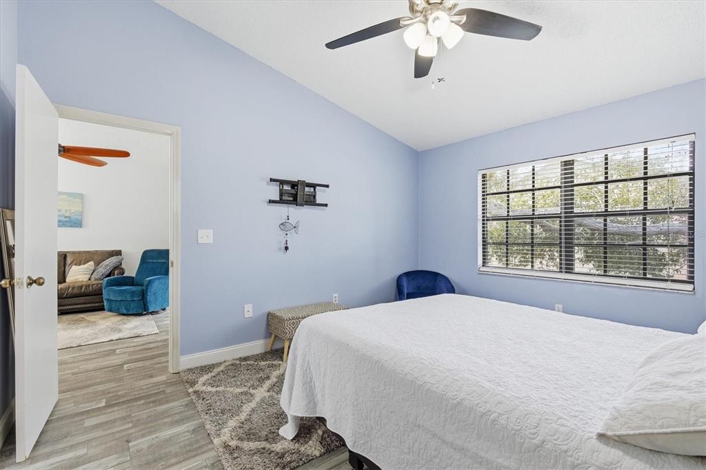 2178 Elm Street, Unit 1007 Dunedin, FL 34698 - Photo 16 of 28 a bedroom with a large bed and a chandelier