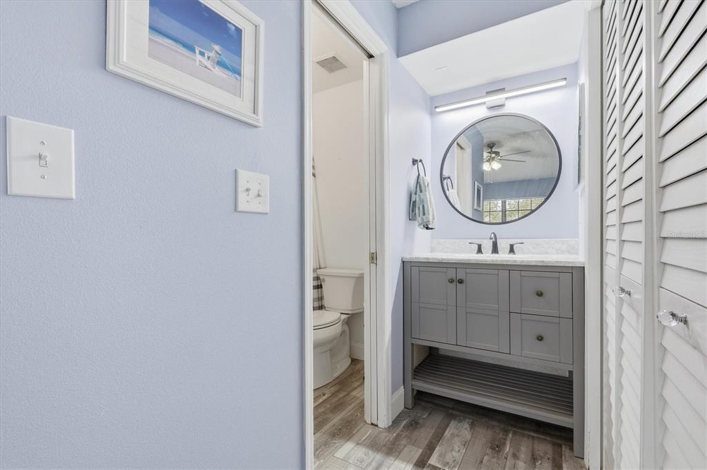 2178 Elm Street, Unit 1007 Dunedin, FL 34698 - Photo 18 of 28 a bathroom with a double vanity sink and a mirror