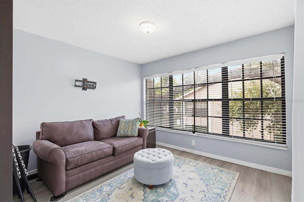2178 Elm Street, Unit 1007 Dunedin, FL 34698 - Photo 20 of 28 a living room with furniture and a large window