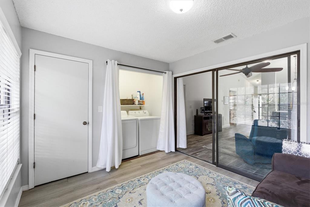 2178 Elm Street, Unit 1007 Dunedin, FL 34698 - Photo 21 of 28 a living room with a couch next to a window