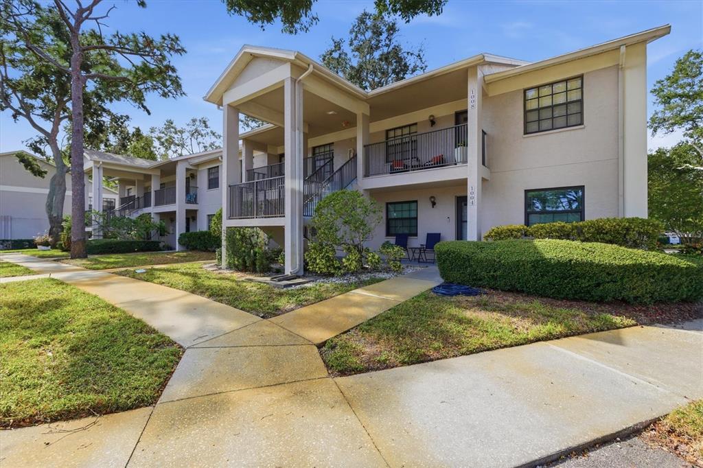 2178 Elm Street, Unit 1007 Dunedin, FL 34698 - Photo 4 of 28 a view of a building with a yard