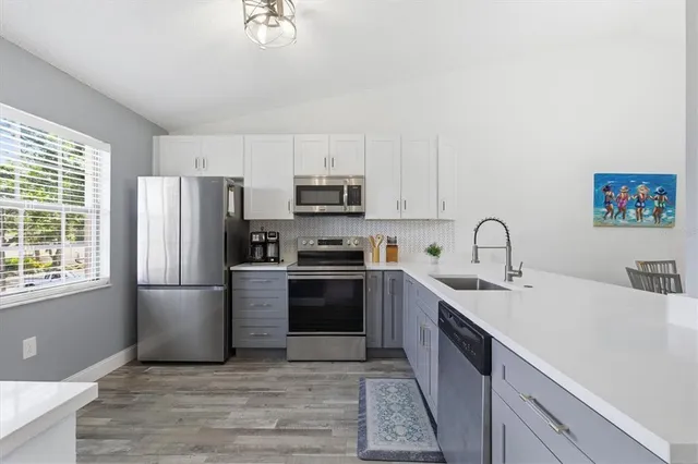 a kitchen with a refrigerator stove and sink