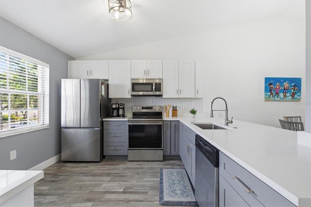 2178 Elm Street, Unit 1007 Dunedin, FL 34698 - Photo 7 of 28 a kitchen with a refrigerator stove and sink