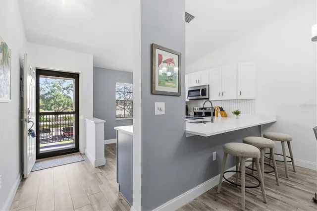 a view of kitchen with furniture and wooden floor