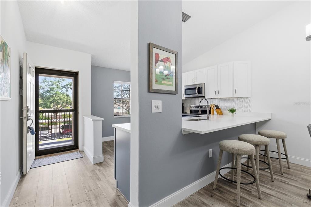 2178 Elm Street, Unit 1007 Dunedin, FL 34698 - Photo 9 of 28 a view of kitchen with furniture and wooden floor