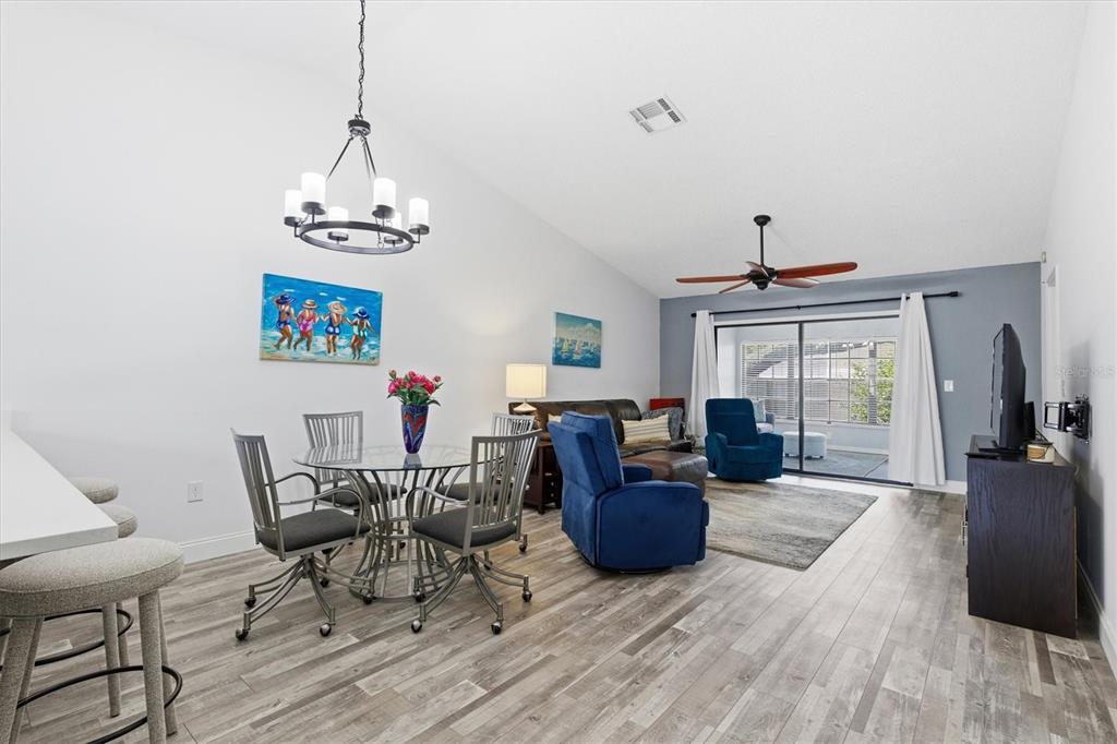 2178 Elm Street, Unit 1007 Dunedin, FL 34698 - Photo 10 of 28 a living room with furniture and a chandelier